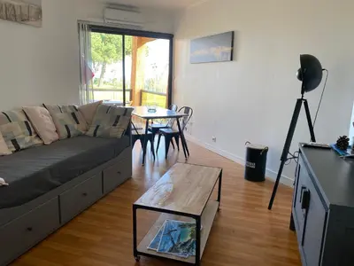 a living room with a couch and a table at Residence Santa Lucia, studio avec piscine , vue mer et pied dans l'eau , Moriani-Plage in Santa-Lucia-di-Moriani