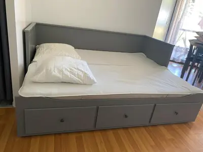a bed with white sheets and white pillows on it at Residence Santa Lucia, studio avec piscine , vue mer et pied dans l'eau , Moriani-Plage in Santa-Lucia-di-Moriani