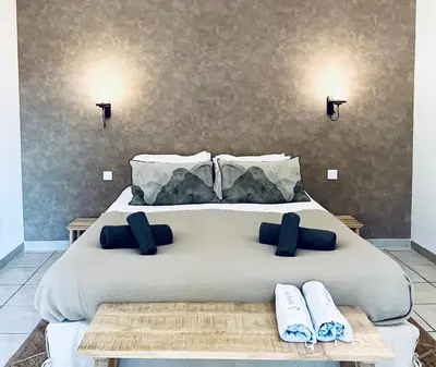 a bedroom with a large bed with two slippers on it at Domaine de Licetto in Bonifacio