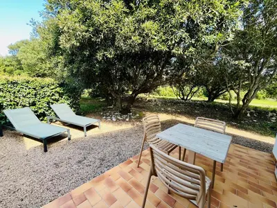 two chairs and a table and a table and chairs on a patio at Domaine de Licetto in Bonifacio