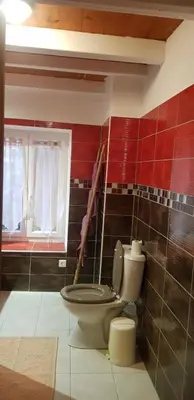 a bathroom with a toilet and a window at L'Orca di San Gavinu in Figari