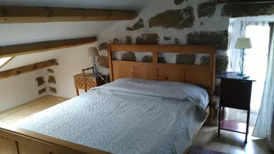 a bedroom with a wooden bed in a room at L'Orca di San Gavinu in Figari