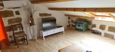 a living room with a flat screen tv on a white cabinet at L'Orca di San Gavinu in Figari
