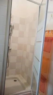 a shower with a glass door in a bathroom at L'Orca di San Gavinu in Figari