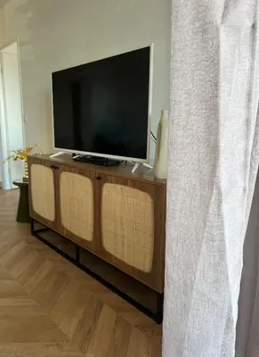 a flat screen tv sitting on top of a wooden entertainment center at T2 Ajaccio vue mer in Ajaccio