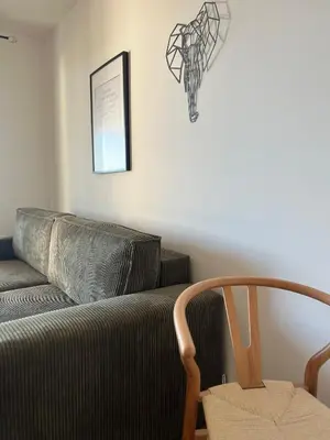 a living room with a couch and a chair at T2 Ajaccio vue mer in Ajaccio