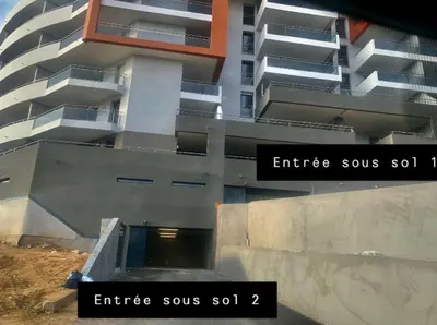 an external view of an apartment building with two signs at T2 Ajaccio vue mer in Ajaccio