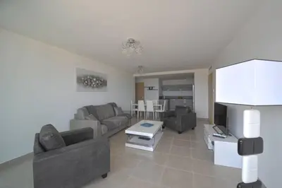 a living room with two couches and a tv at Bel appartement vue mer Porto Vecchio in Porto-Vecchio