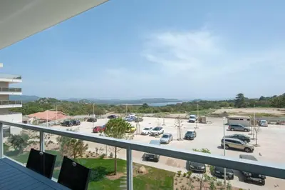 a view of a parking lot from a balcony at Bel appartement vue mer Porto Vecchio in Porto-Vecchio