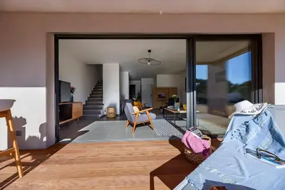 a living room with a couch and a table at Hotel Calarossa Bay Resort in Porto-Vecchio