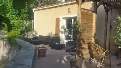 a patio with couches and chairs and a building at Maison 4 Pers - Vue mer et vignoble exceptionnelle in Poggio-dʼOletta