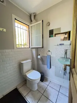 a bathroom with a toilet and a sink at Maison 4 Pers - Vue mer et vignoble exceptionnelle in Poggio-dʼOletta