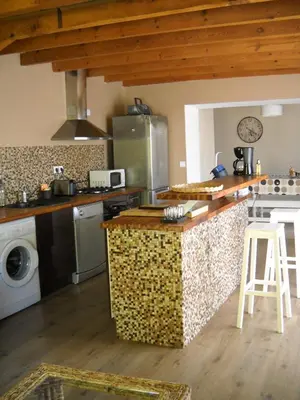 a kitchen with a stove and a counter top at Maison 4 Pers - Vue mer et vignoble exceptionnelle in Poggio-dʼOletta