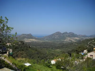 a view of a valley with mountains in the distance at Maison 4 Pers - Vue mer et vignoble exceptionnelle in Poggio-dʼOletta