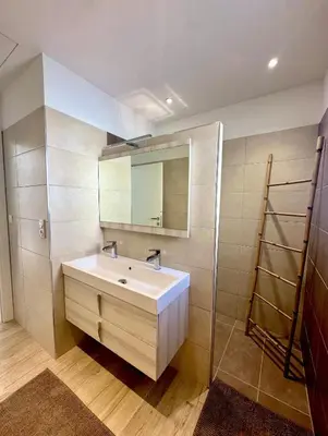 a bathroom with a white sink and a mirror at VILLA JUWEN in Oletta