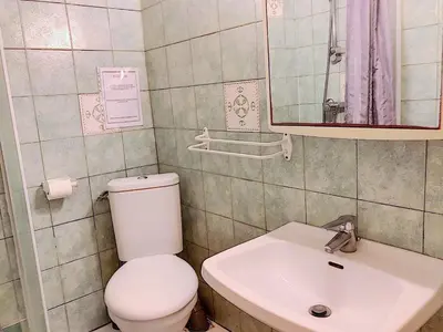 a bathroom with a white toilet and a sink at Terracorse in Figari