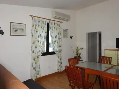 a dining room with a table and a window at Terracorse in Figari