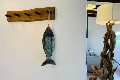 a fish hook hanging on a wall in a living room at Charmante villa 2 chambres les pieds dans l'eau Bonifacio in Bonifacio