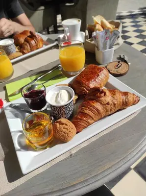 a plate of pastries and croissants on a table at Hôtel Cantu di Fiumu in Zonza