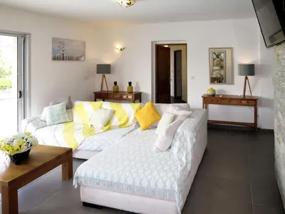 a living room with a white couch and yellow pillows at Holiday Home Villa Ottavi by Interhome in Sainte-Lucie de Porto-Vecchio