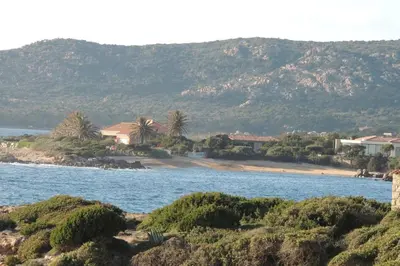 a view of a body of water with mountains in the background at Appartement vue piscine dans résidence de standing in Porto-Vecchio