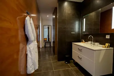 two boxes sitting on top of a table with a bag at SWIM LODGE HOTEL Piscine privée ou Jacuzzi privé in Porto-Vecchio