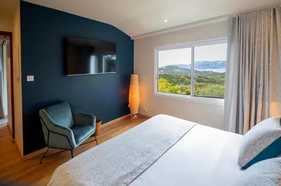 a kitchen with a sink and a wooden table at SWIM LODGE HOTEL Piscine privée ou Jacuzzi privé in Porto-Vecchio