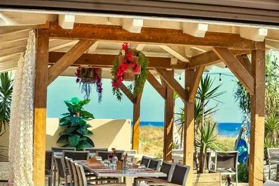 a table and chairs under a wooden pergola at Résidence San Pellegrino in Folelli