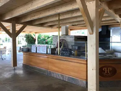 a restaurant with a wooden counter with a counter top at Résidence San Pellegrino in Folelli