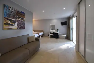 a living room with a couch and a bedroom at Résidence San Pellegrino in Folelli