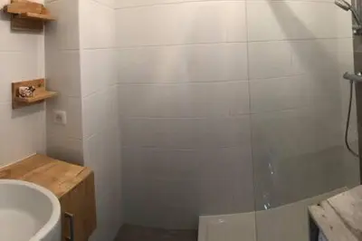 a bathroom with a shower and a tub and a sink at Magnifique T1 Bis Vue mer Route des sanguinaires Ajaccio in Ajaccio