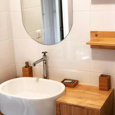 a bathroom with a white sink and a mirror at Magnifique T1 Bis Vue mer Route des sanguinaires Ajaccio in Ajaccio