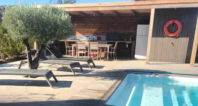 a patio with a swimming pool and a table and chairs at Casa Fiumu Oso in San-Gavino-di-Carbini