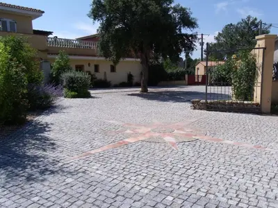 a large pink star on a brick driveway at Résidence du pont de l'Oso in Porto-Vecchio