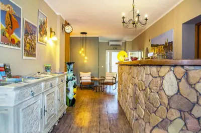 a kitchen with a stone counter and a dining room at Résidence du pont de l'Oso in Porto-Vecchio