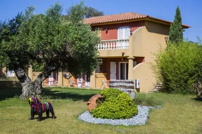 a statue of a horse in front of a house at Résidence du pont de l'Oso in Porto-Vecchio