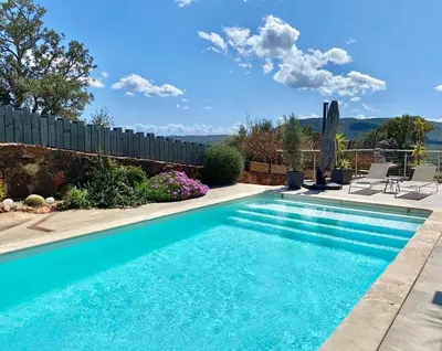 a swimming pool in a yard with a fence at VILLA CARAMONTINU SERENA à Pinarello, proche plage, vue mer, piscine chauffée in Zonza