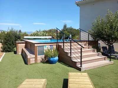 a backyard with a swimming pool and a house at L'Alivu in Ajaccio