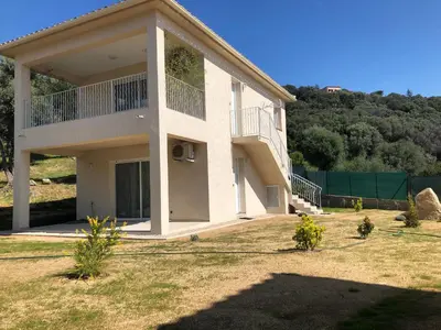 a large white house with a large yard at L'Alivu in Ajaccio