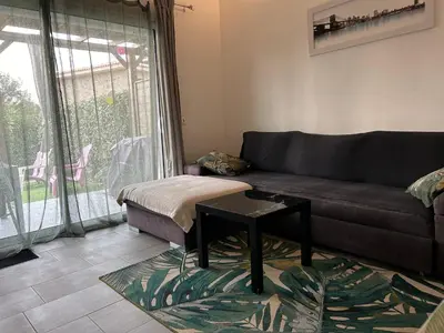 a living room with a couch and a table at Chez Muriel in Porto-Vecchio