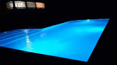 a blue swimming pool in a dark room at Mini Villa - Corse du Sud in Lecci