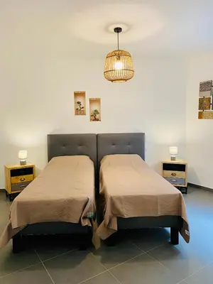 two beds sitting next to each other in a room at Fronte di Mare 2 chambres vue mer - 1 in Propriano