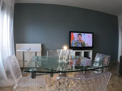 a dining room with a glass table and chairs at PASSERELLE DU MARIN in Ajaccio