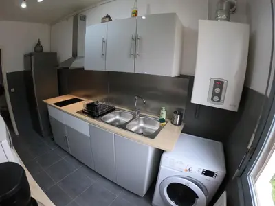 a small kitchen with a sink and a washing machine at PASSERELLE DU MARIN in Ajaccio