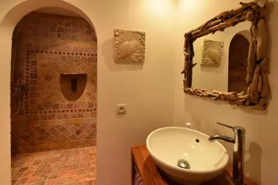 a bathroom with a sink and a shower with a mirror at Domaine Panciarella in Saint-Florent
