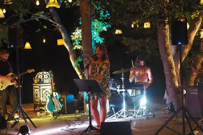 a group of people playing music on a stage at Domaine Panciarella in Saint-Florent