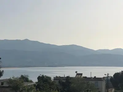 a view of a large body of water with a building at Bel appartement f3 vue sur le golfe d’ajaccio in Ajaccio