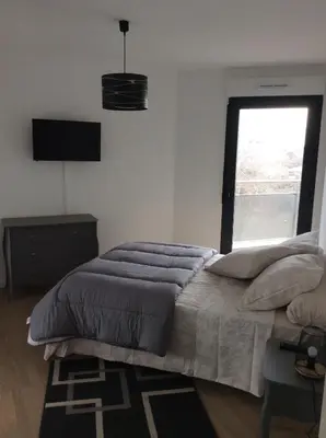 a bedroom with a large bed and a window at Bel appartement f3 vue sur le golfe d’ajaccio in Ajaccio