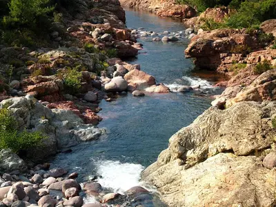 a river with rocks on a rocky mountain at Maison de caractère, pierre sèche, Galéria, pour 2 in Galeria