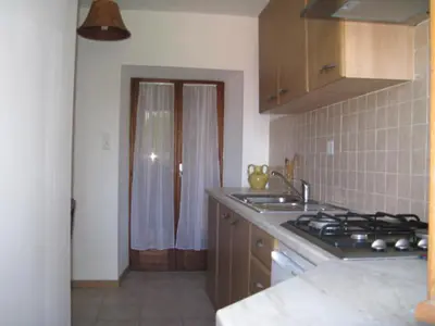 a kitchen with a sink and a stove top oven at Maison de caractère, pierre sèche, Galéria, pour 2 in Galeria